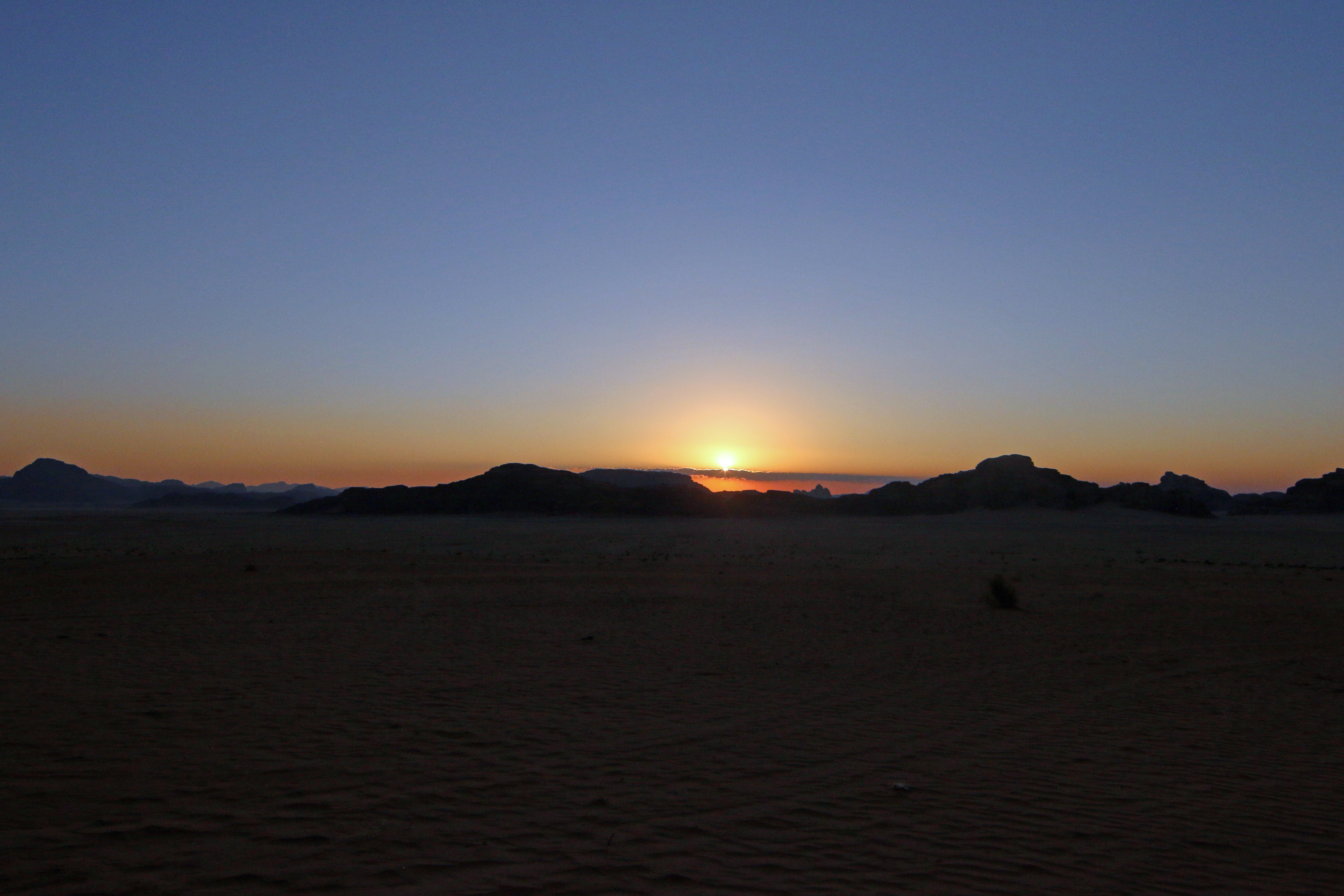 Sun descends on Wadi Rum.